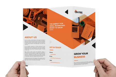 hands holing up a marketing brochure
